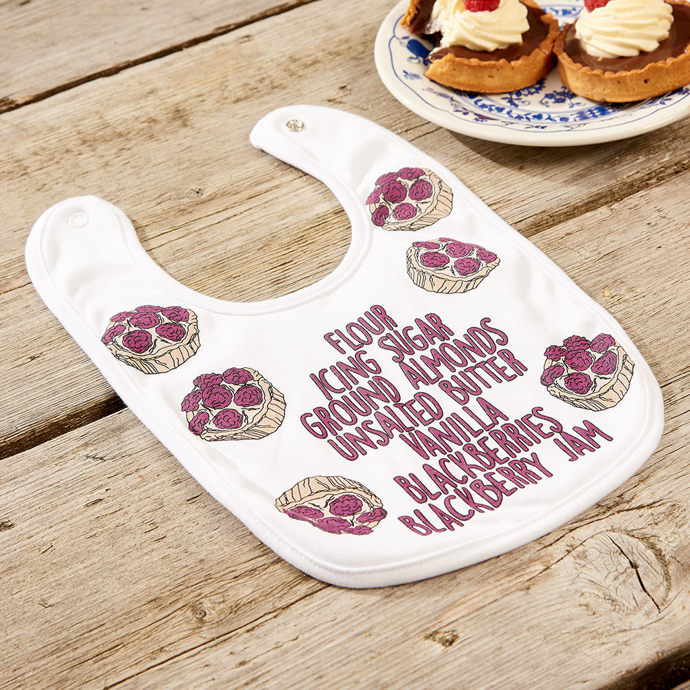 Children's & Baby Clothes Photography, baby bib with cupcake print photographed on a wooden table