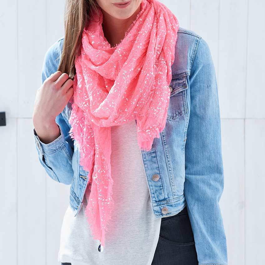 Brighton photography studio fashion photograph of a female model wearing a pink scarf and denim jacket against a wooden white background