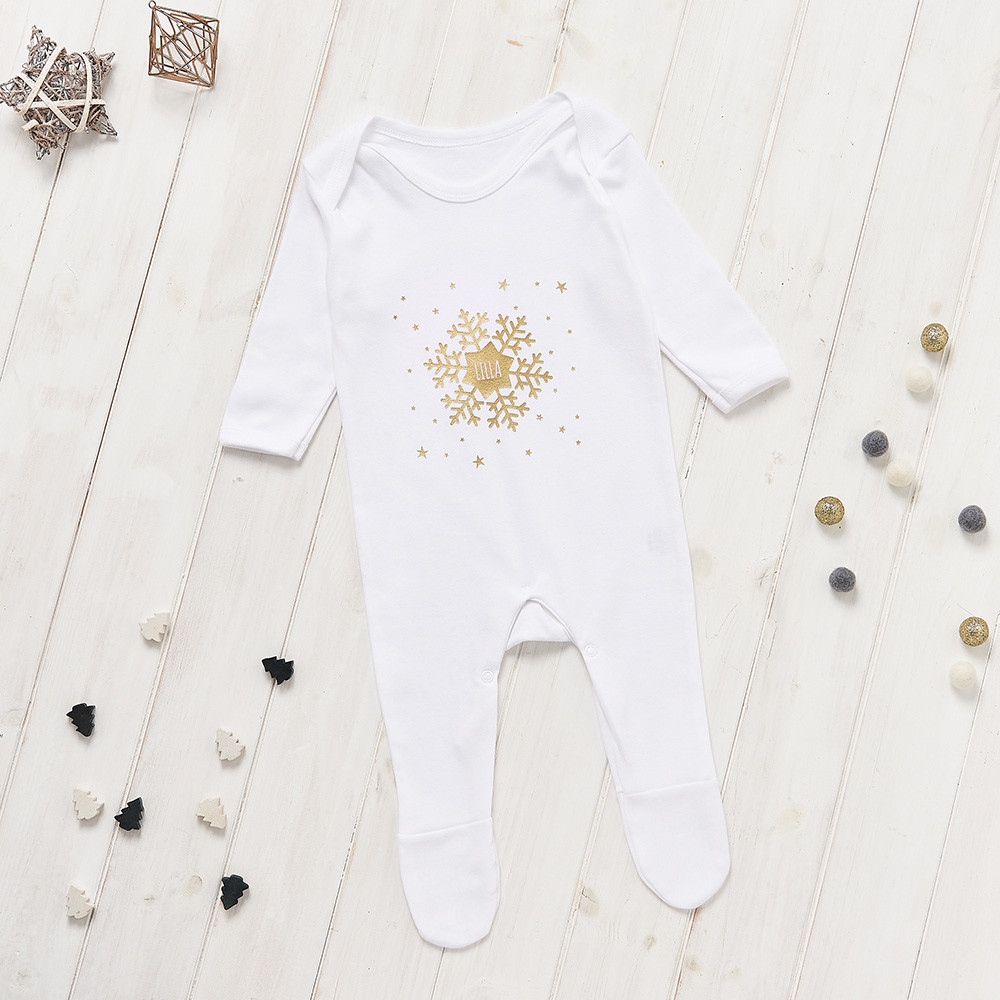 Christmas lifestyle photography, white baby grow with snowflake print and props