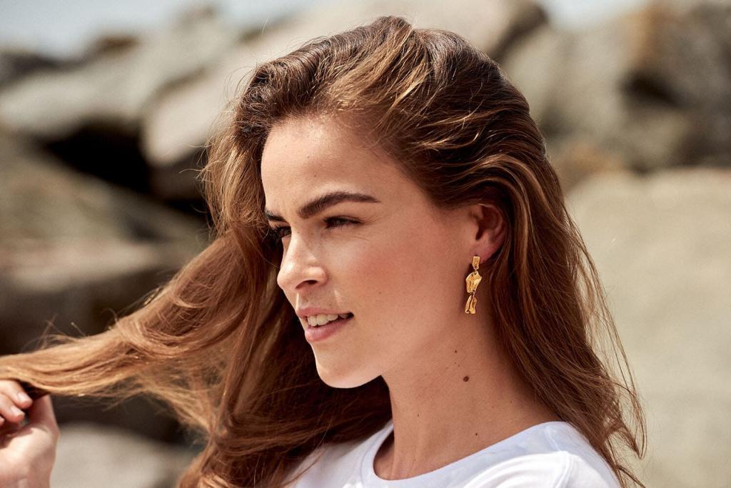 on location jewellery photo shoot, brunette model wears earrings